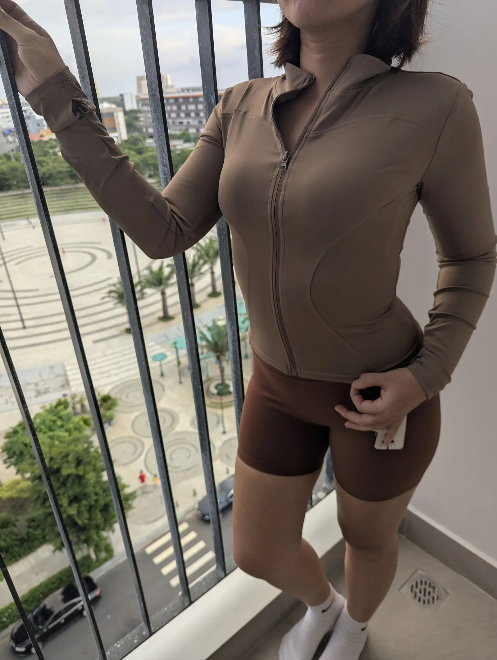 Mocha zip jacket worn with brown biker shorts, front view